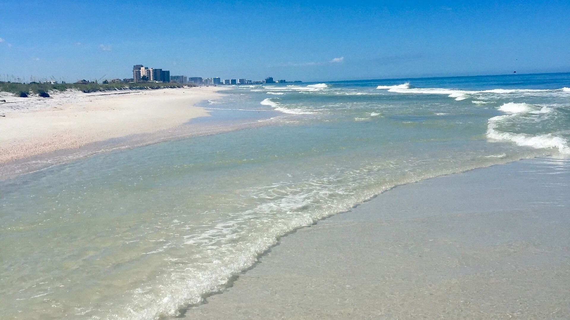 Pale sand and the shoreline at North Clearwater Beach