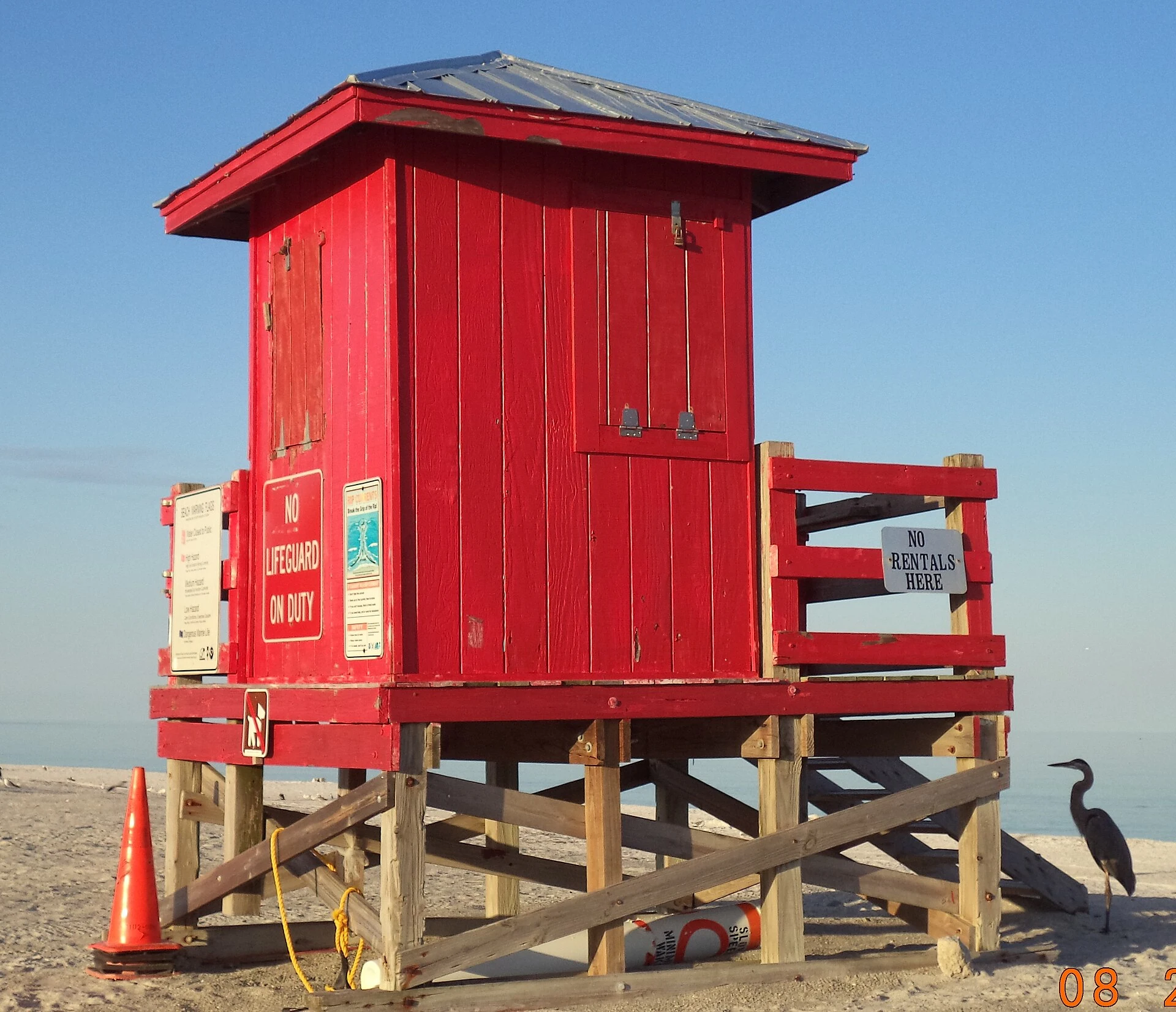 A red lifeguard structure on the sand at Sand Key Park